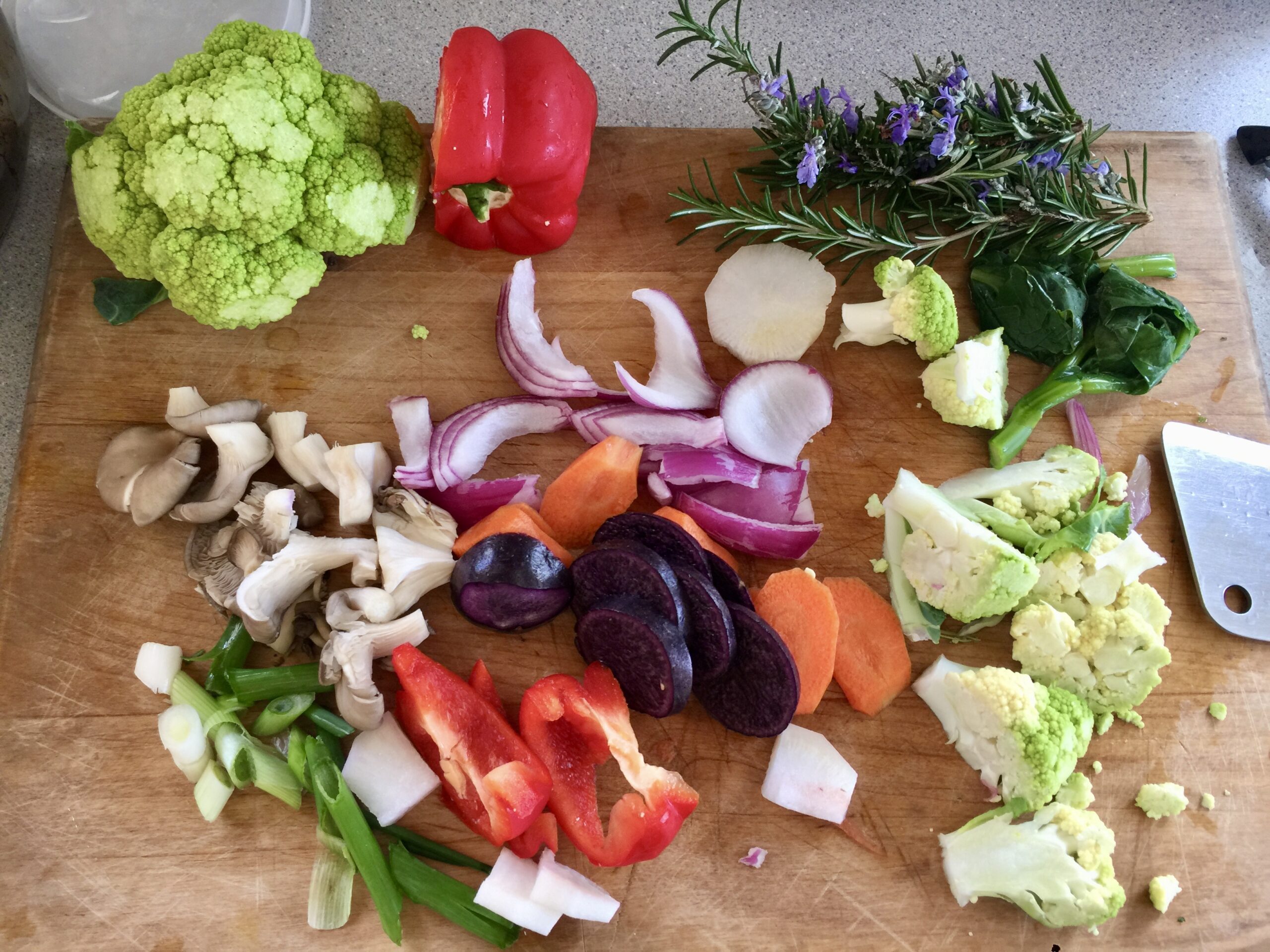 Vegetable prep with bright colored vegetables, purple potato, green cauliflower